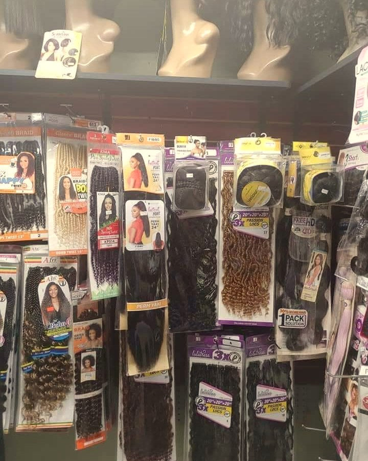 Wall of packaged hair with display heads, Adele's Beauty Supply, 2021