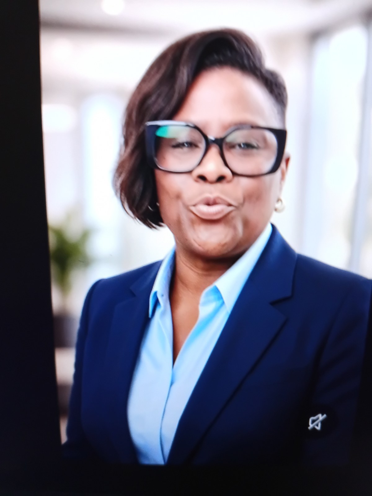 Portrait of Adele, co-owner of Adele's Beauty Supply, in a navy blazer